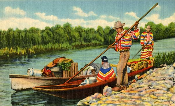 Seminole Indians in the Everglades moving in dugout canoes.